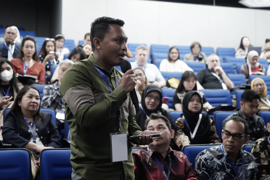 An audience member asking a question with a microphone