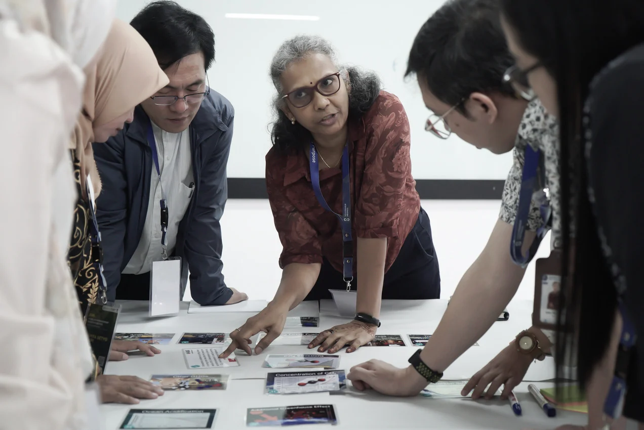 Participants working with cards on a table during a workshop